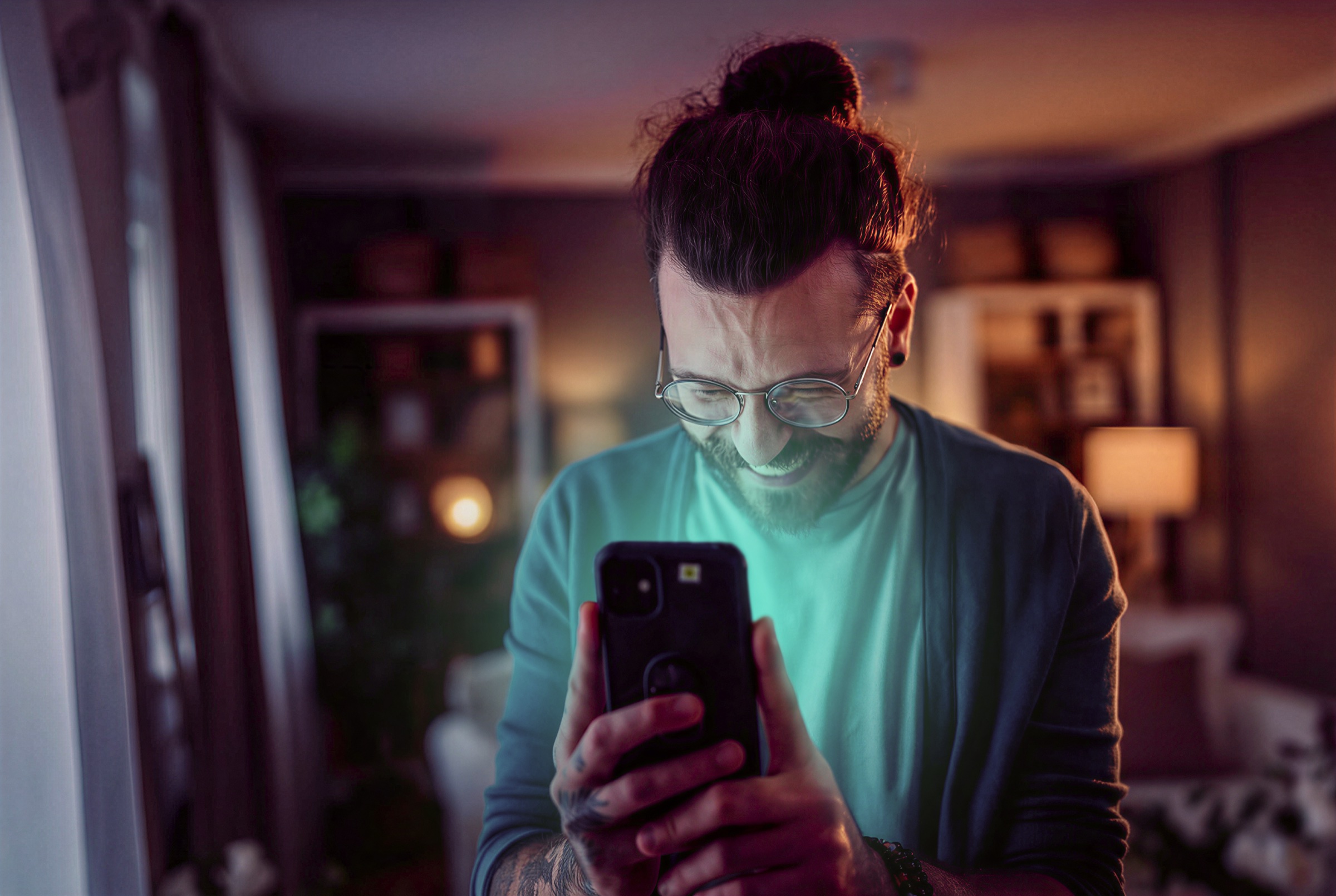 Stock image of a housing seeker checking a listing on his phone, transformed for the campaign