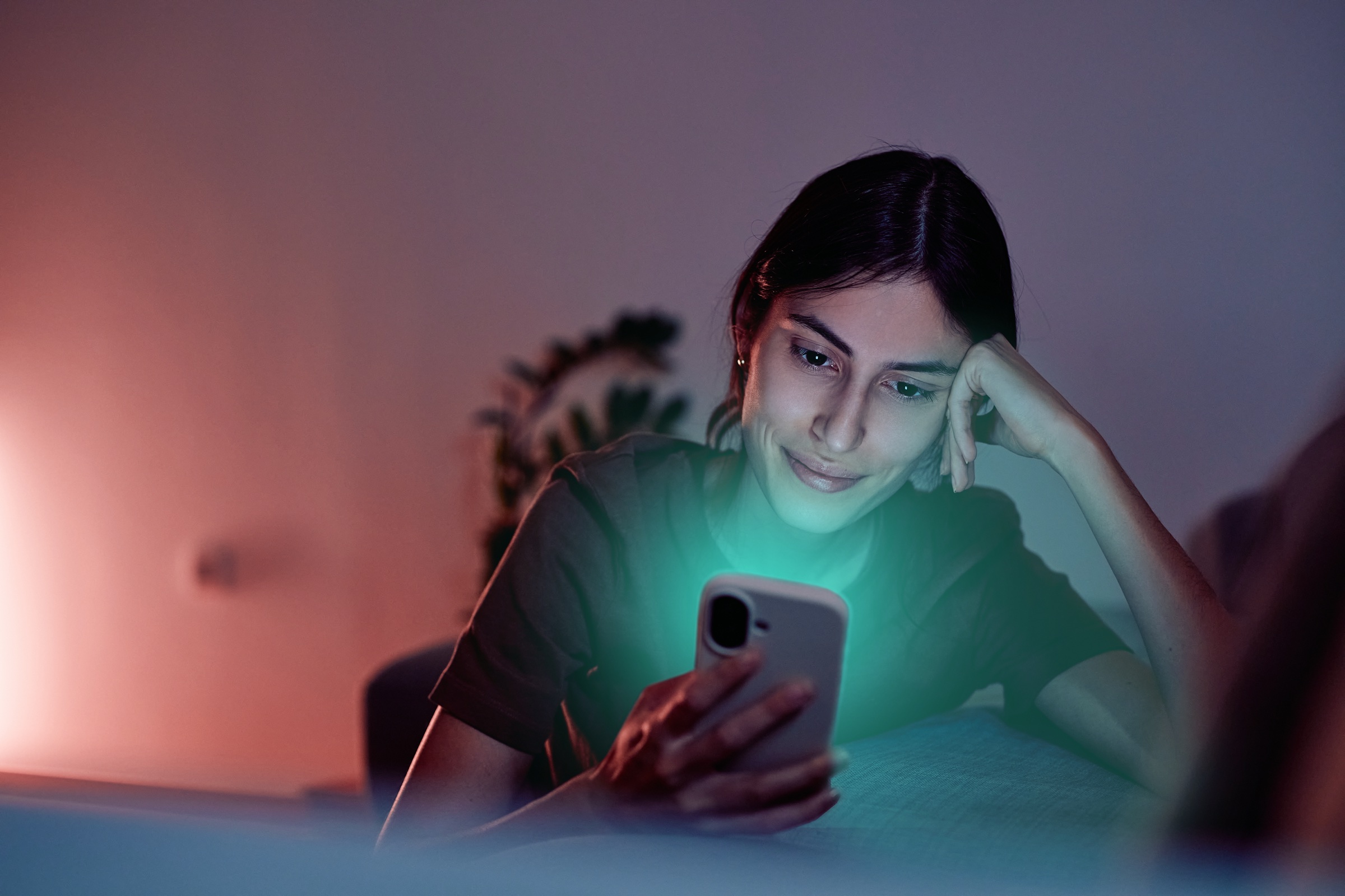 Stock image of a housing seeker checking her phone at home, transformed for the campaign